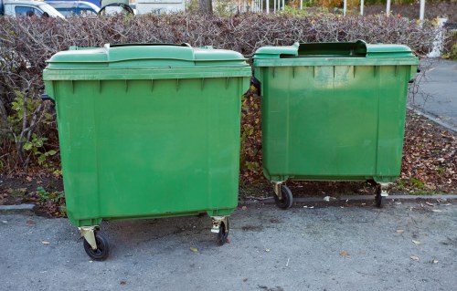 Family unloading waste into a skip in Clapham
