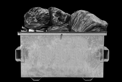 Team wearing PPE loading a skip safely